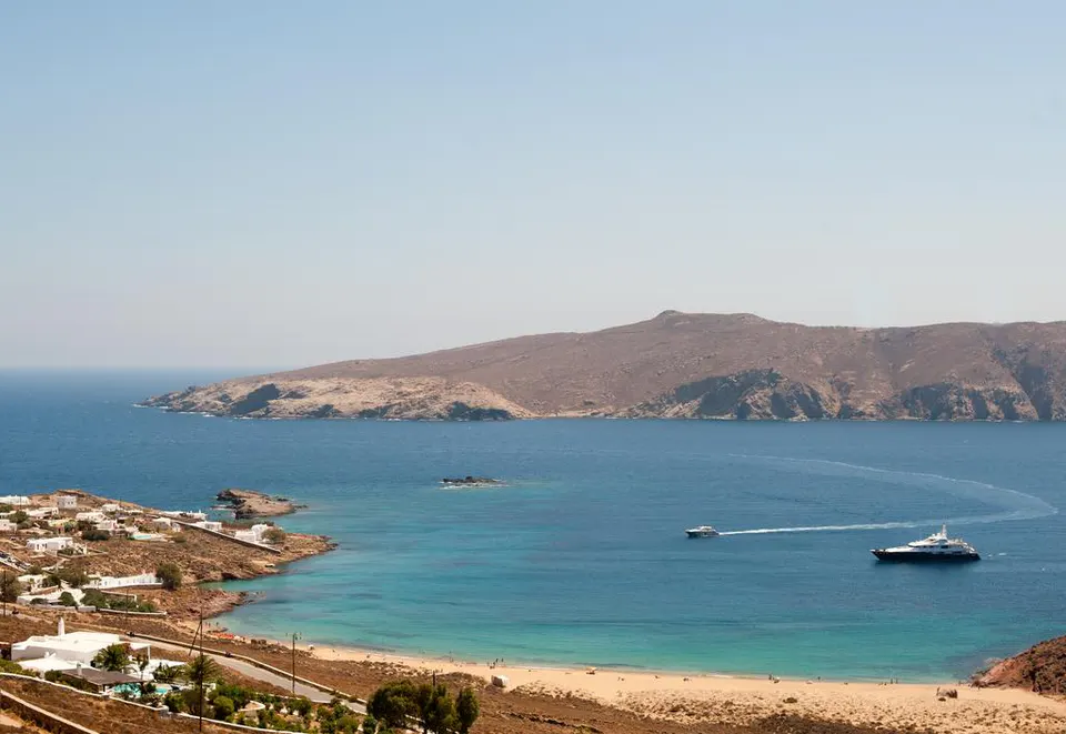 Bay with a sandy beach and an island beyond, seen from above
