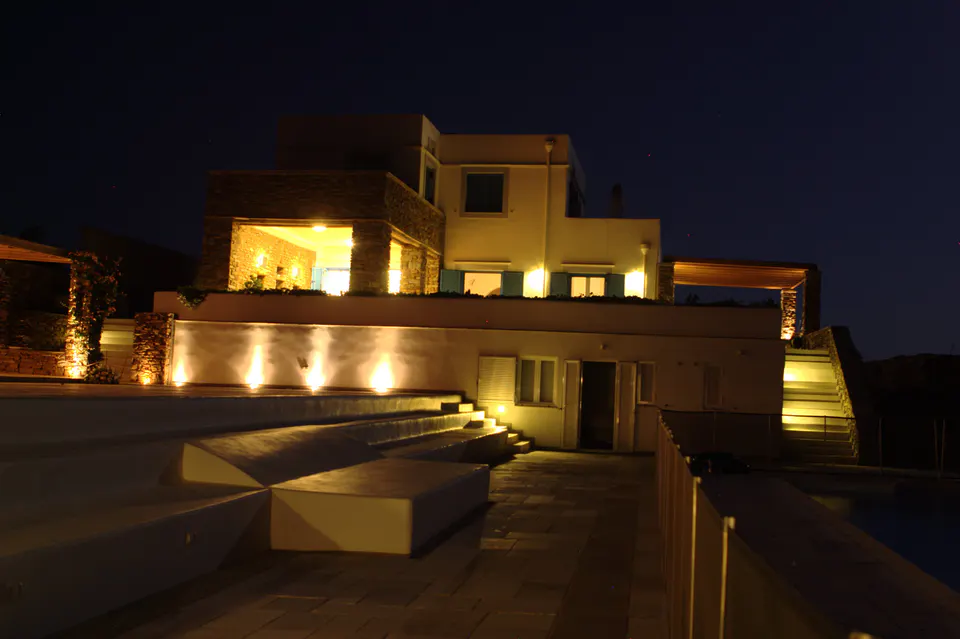 The house and terrace lit up at night